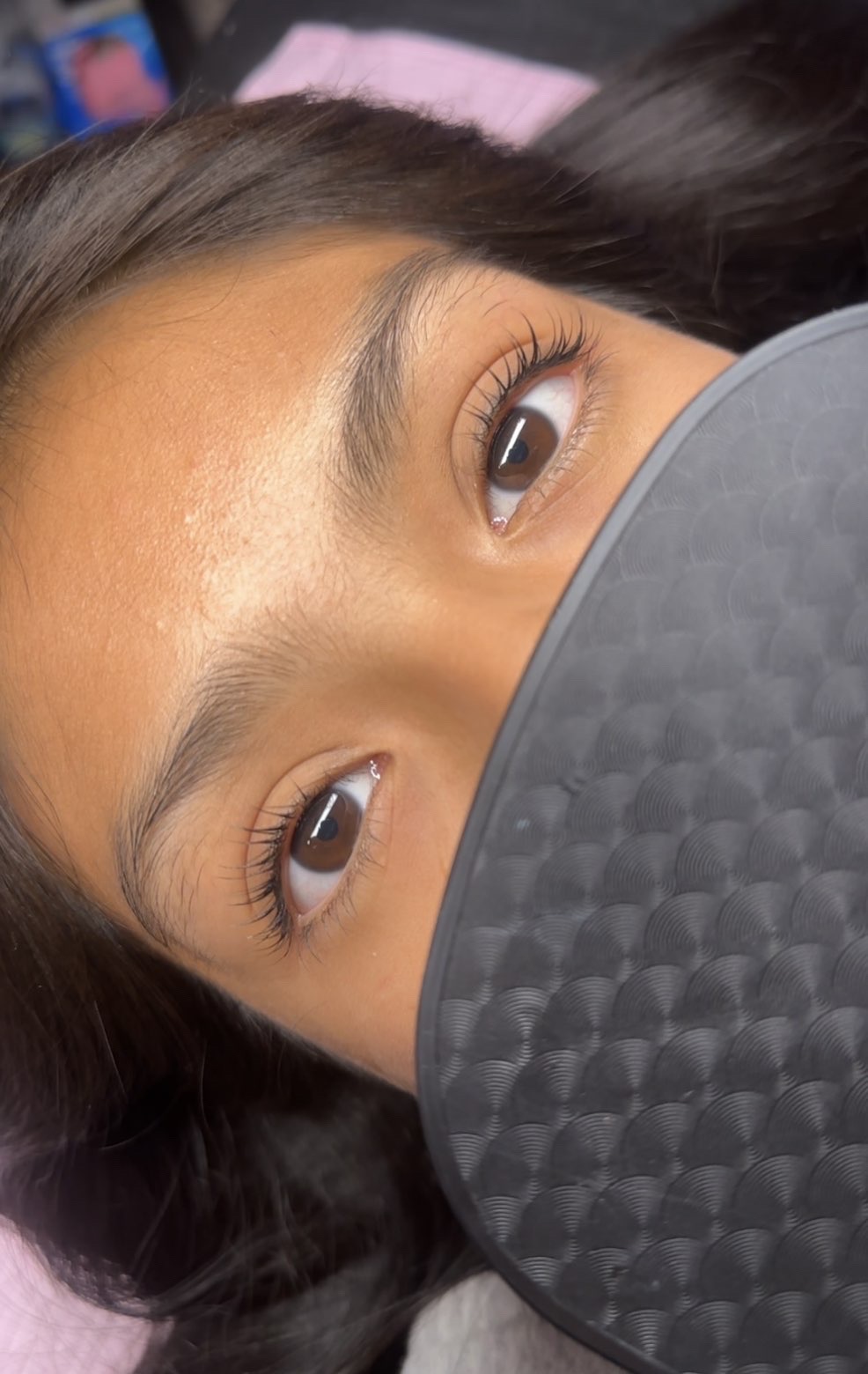 After: the same client's lashes curled upward and darker, making them look longer and more visible.